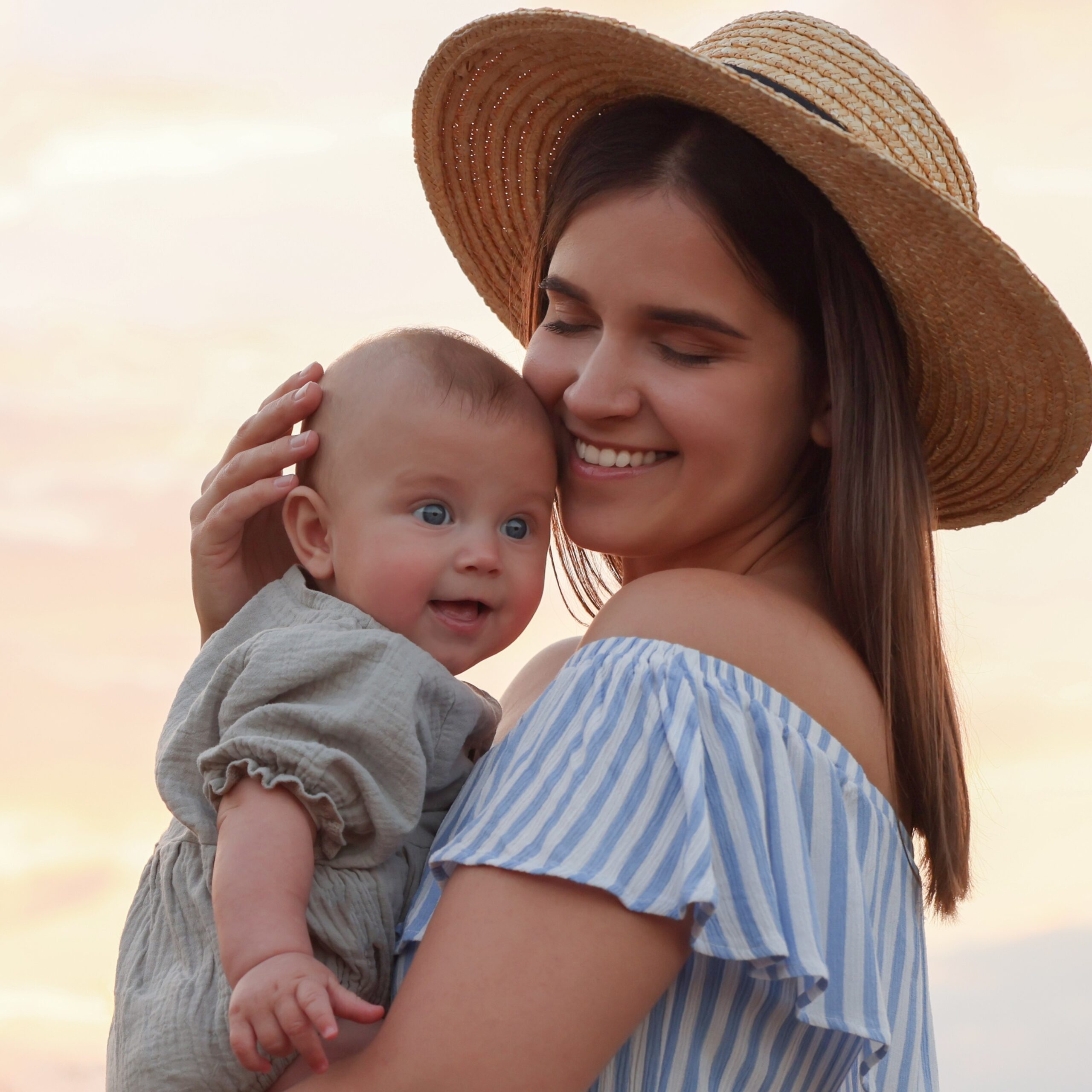 Happy Mother With Adorable Baby In Field At Sunset, Space For Text Woman looking for free baby clothes and maternity items in Bedford, Indiana
